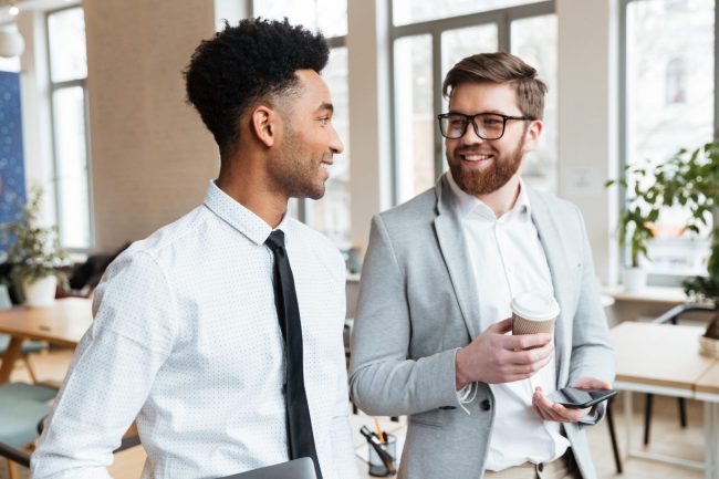 Photo of businessmen talking illustrates blog: "Crafting the Perfect Business Pitch"