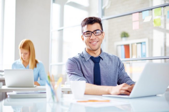 Photo of man n front of computer illustrates blog: "How to Craft the Perfect Business Pitch"