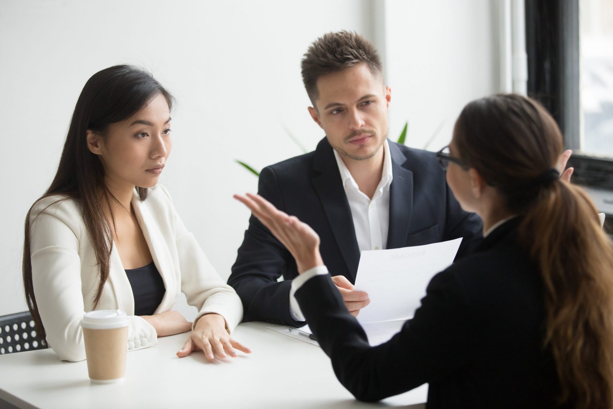 Photo of two women and a man talking illustrates blog: "Handling Criticism as a leader"