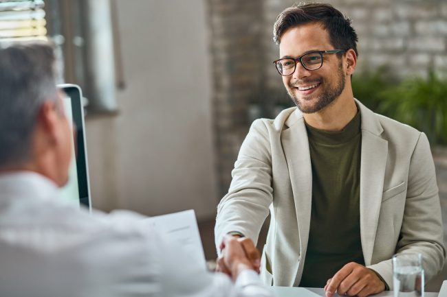 Photo of men shaking hans illustrates blog: "How to improve your hiring in 2023"