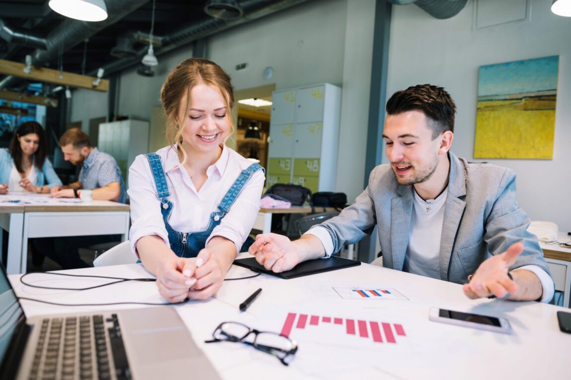 Photo of man and woman talking illustrates blog "A Simple Guide to More Engaging Team Meetings"