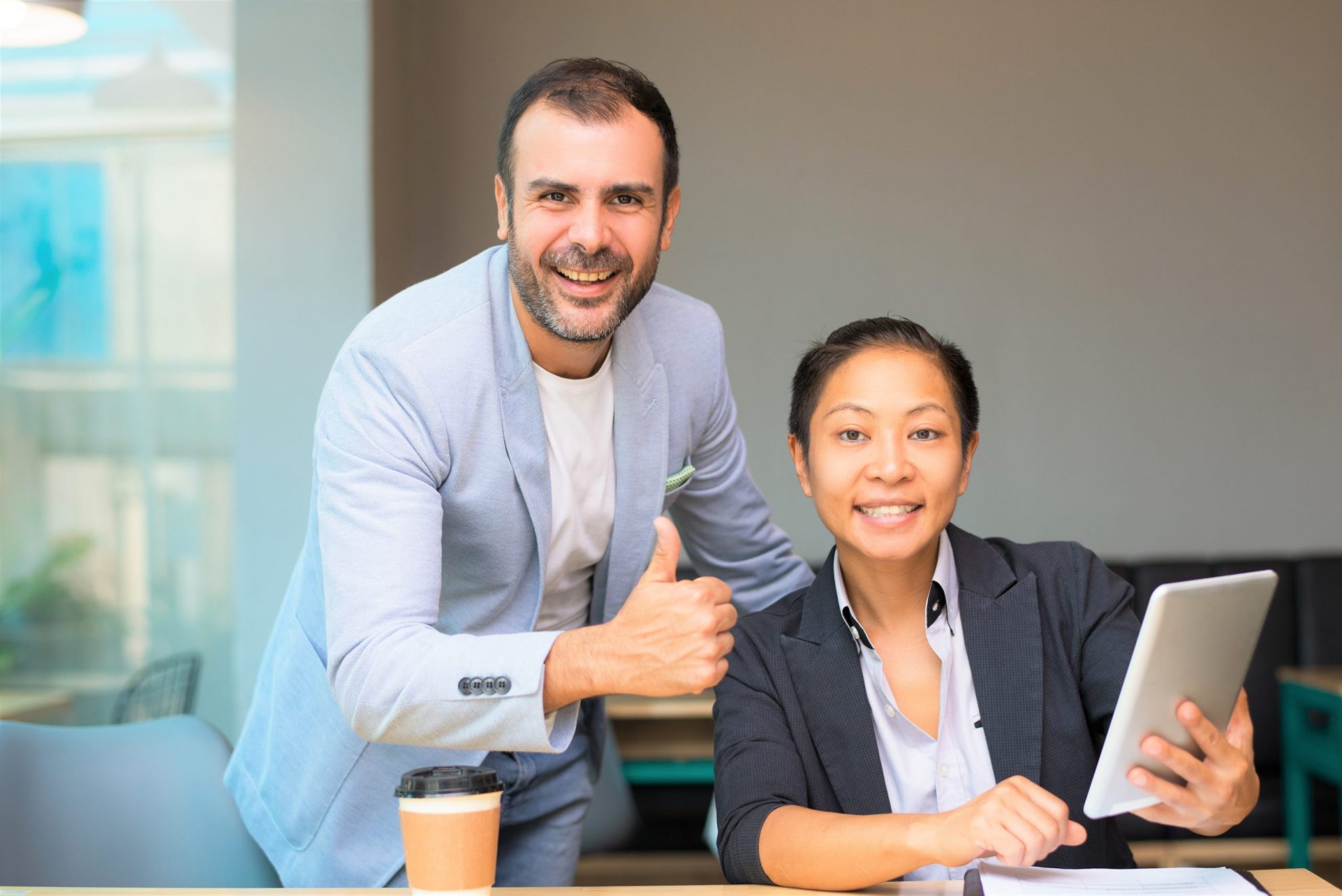 Photo of man giving the thumbs up with woman by his side illustrates blog: "Can Teamwork Be Taught?"