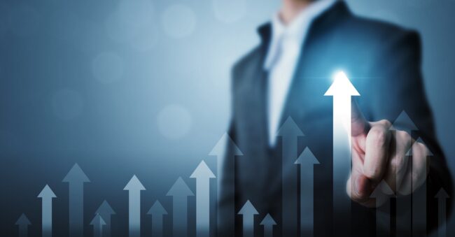 Photo of man touching arrow pointing up illustrates blog "How To Boost Productivity in Your Business"