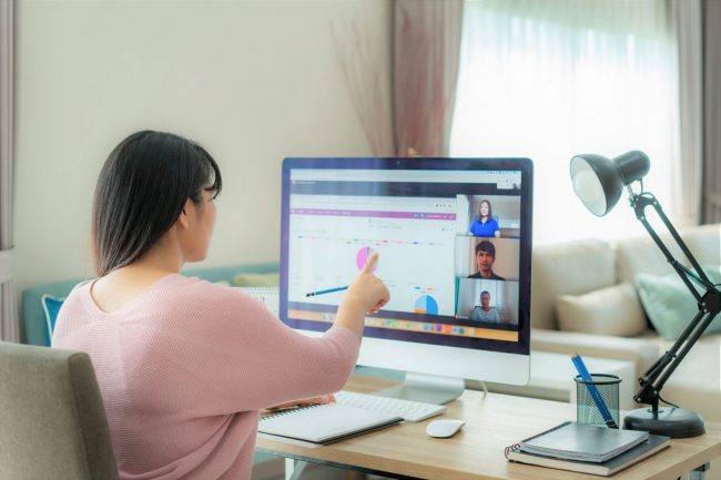 Photo of girl in front of computer illustrates blog: "Virtual Meeting Etiquette: 7 Rules You Need to Know"