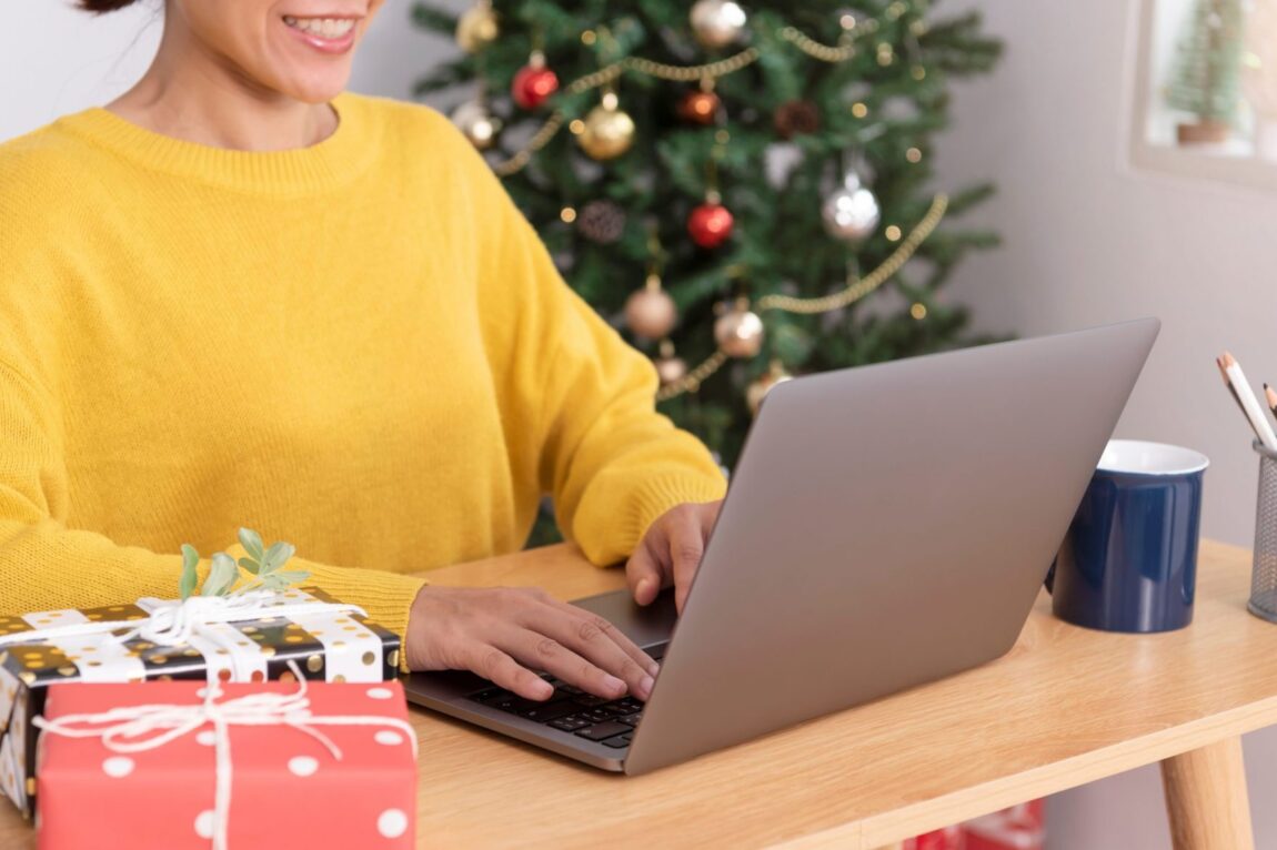Photo of woman working on laptop illustrates blog: "Considering Seasonal Hiring This Christmas? Keep These Tips in Mind"