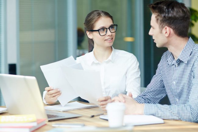 Photo of woman and man talking illustrates blog: "Handling Difficult Conversations at Work"