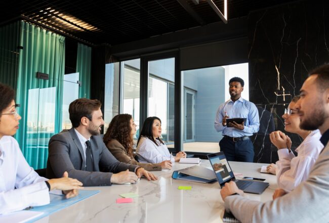 Business people at a meeting illustrates blog "Essential Tips for an Effective Business Strategy"