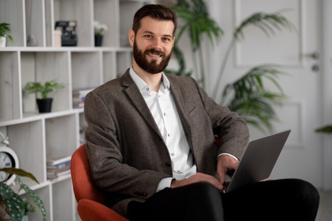 businessman-FP2 Man sitting with laptop illustrates blog "5 Basic Financial Skills (and How To Master Them)"