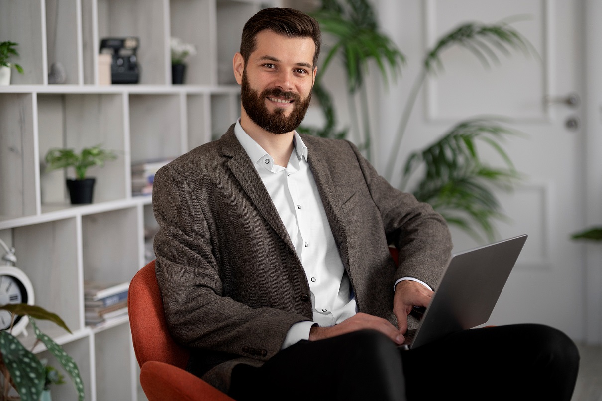 businessman-FP2 Man sitting with laptop illustrates blog "5 Basic Financial Skills (and How To Master Them)"