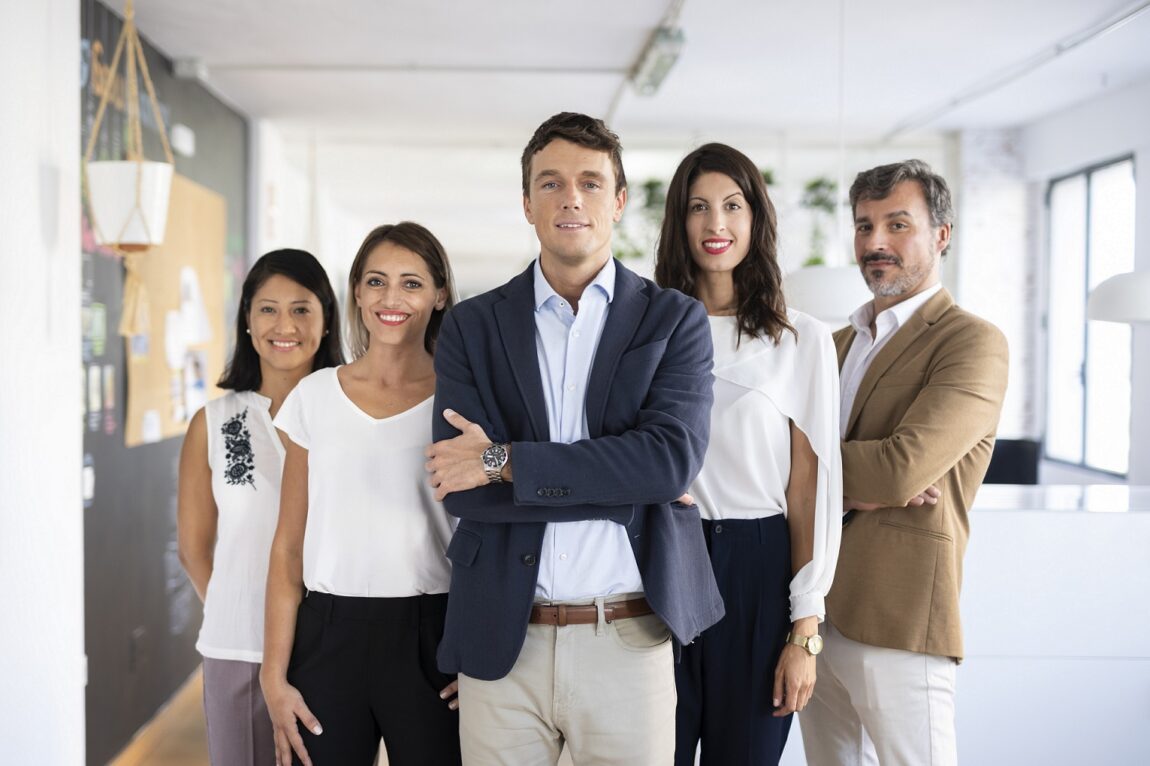 employer-employee2-fp Employer with employee standing behind him in office.