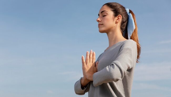 meditatiing-FP Woman meditating illustrates blog "9 Helpful Stress Management Tips"