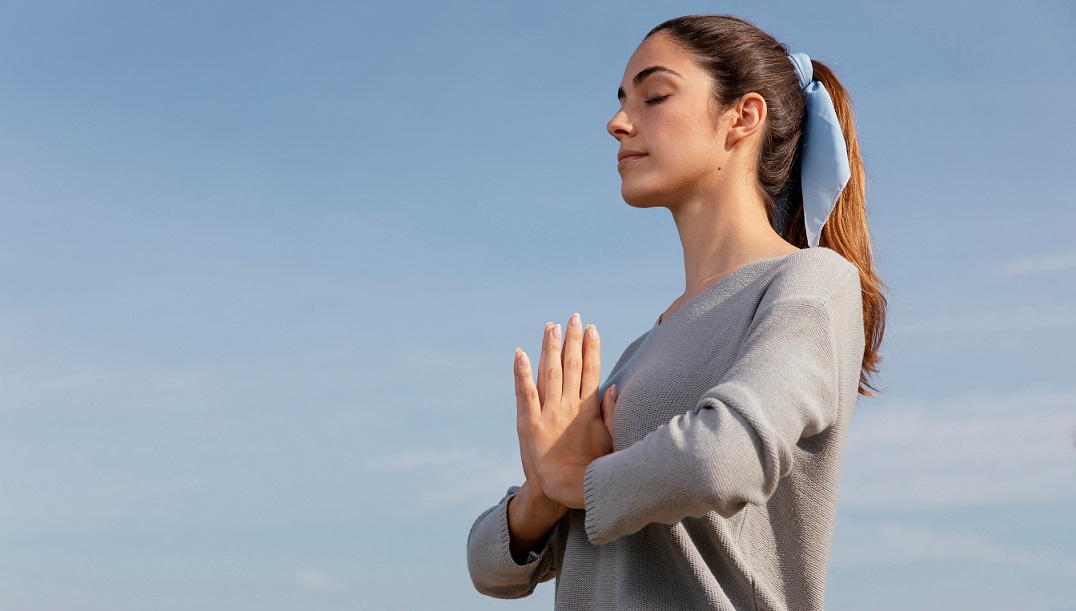 meditatiing-FP Woman meditating illustrates blog "9 Helpful Stress Management Tips"