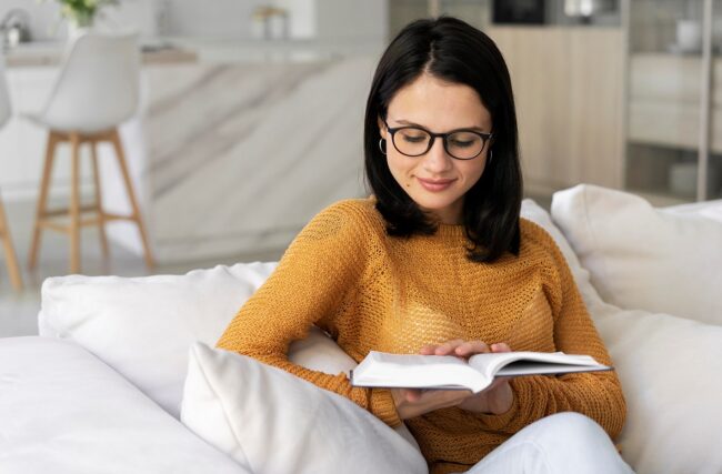 read-book-FP Woman reading book in living room illustrates blog "Should Entrepreneurs Read Books?"