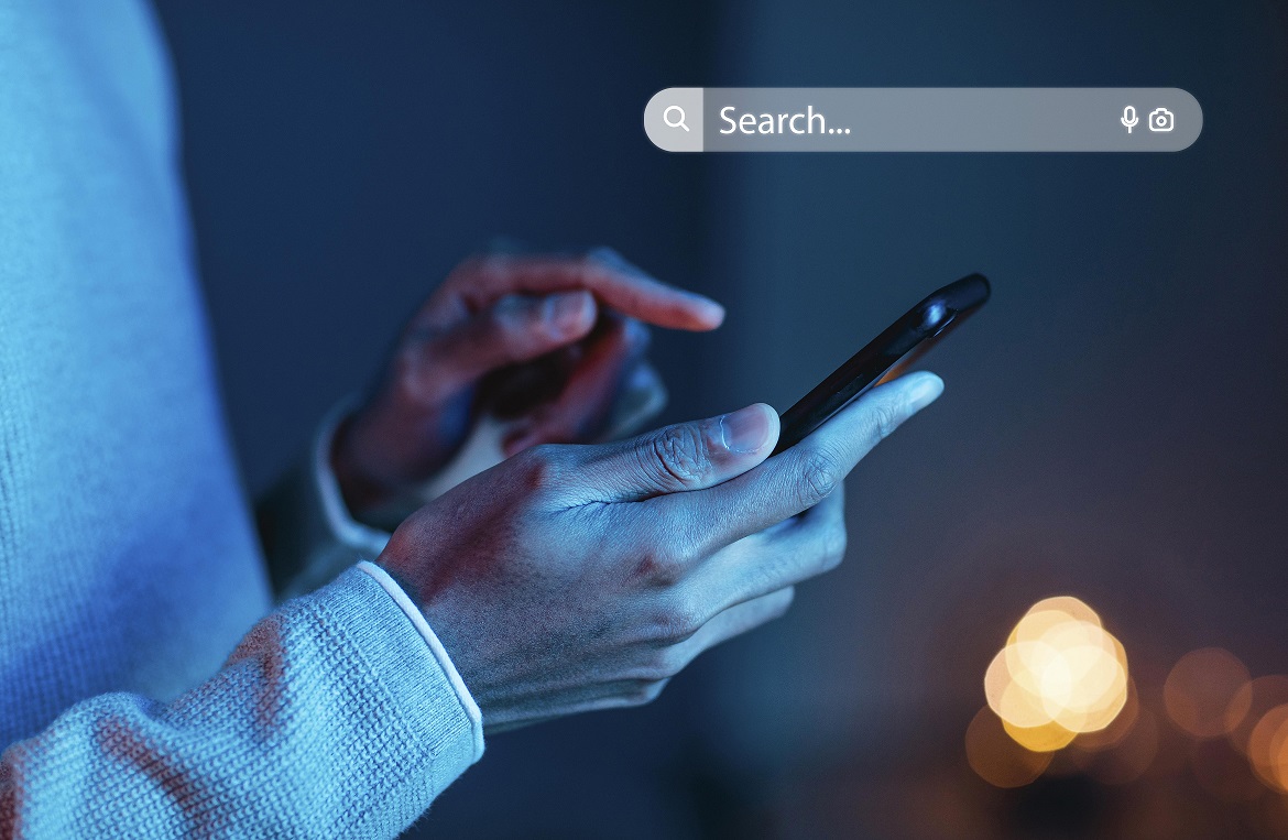 website-fp Closeup of man holding cell phone illustrates blog "Do Businesses Need a Website?"