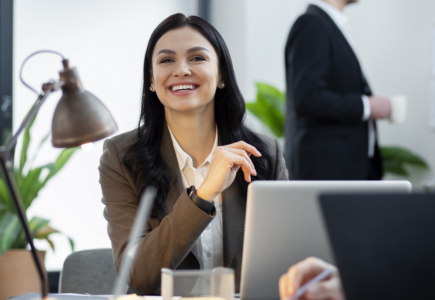 woman-office Smiling woman in business attire illustrates blog "Project Management Basics for Business Owners"